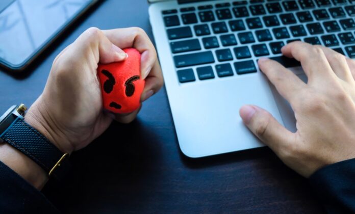 A,Businessman,Squeezing,A,Stress,Ball,On,The,Workspace,On