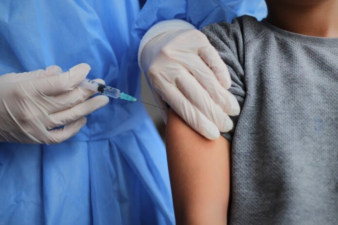 Little,Boy,Getting,Vaccinated,From,Covid-19.,A,Young,Doctot's,Hand